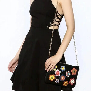 Dress with lace up detail on sides. Zipper in back.